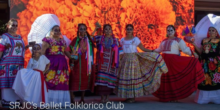 7 women and a child dressed up in colorful traditional mexican folklorico outfits