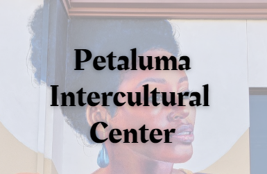 Petaluma Intercultural Center text over a mural of a young woman looking to the left