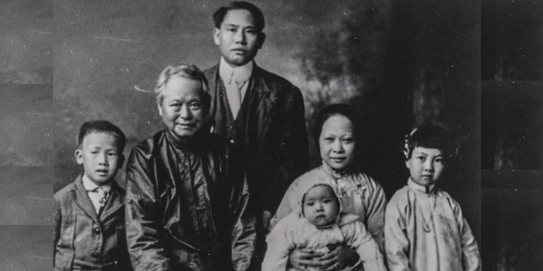 black and white picture of a family of 6, including an elder, two adults, and three young children