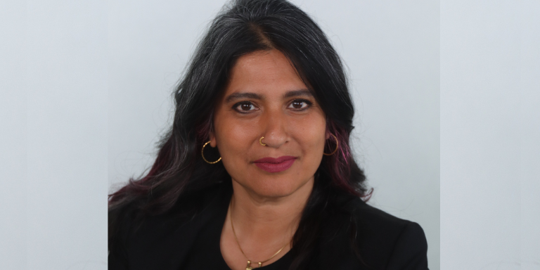 Sonali Kolhatkar smiling at the camera