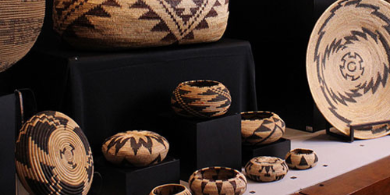 photograph of different size woven baskets lined up on display